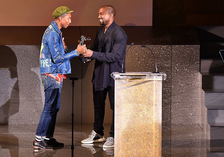 NEW YORK, NY - JUNE 01: Kanye West (R) presents the Fashion Icon Award to Pharrell Williams onstage at the 2015 CFDA Fashion Awards at Alice Tully Hall at Lincoln Center on June 1, 2015 in New York City. (Photo by Michael Loccisano/Getty Images)